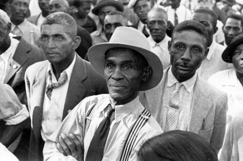 Black men listening to a speaker at an outdoor STFU meeting